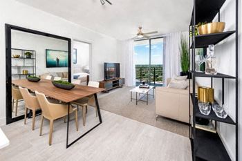 A living room with a wooden table and chairs